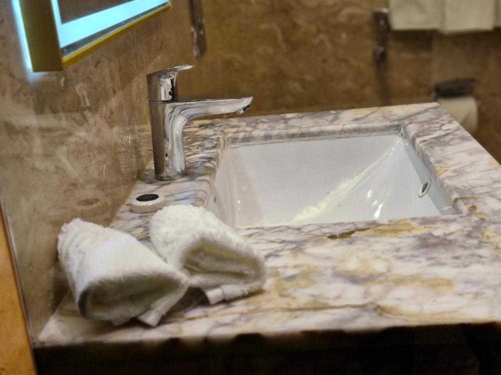 Marble bathroom counter with towels at Hotel in Kuwait