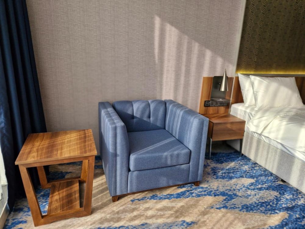 Ocean View Hotel Kuwait room with armchair and twin bed setup