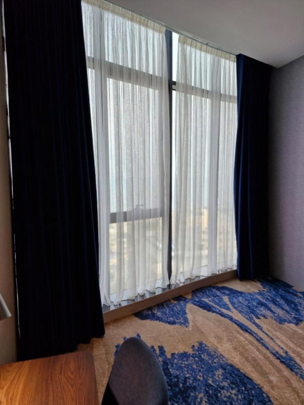 Ocean View Hotel Kuwait room with large windows and sheer curtains