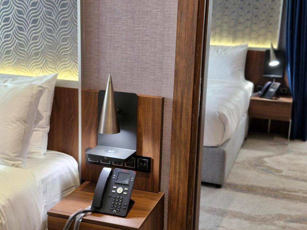 Bedside phone and lighting controls at Hotel in Kuwait guest room