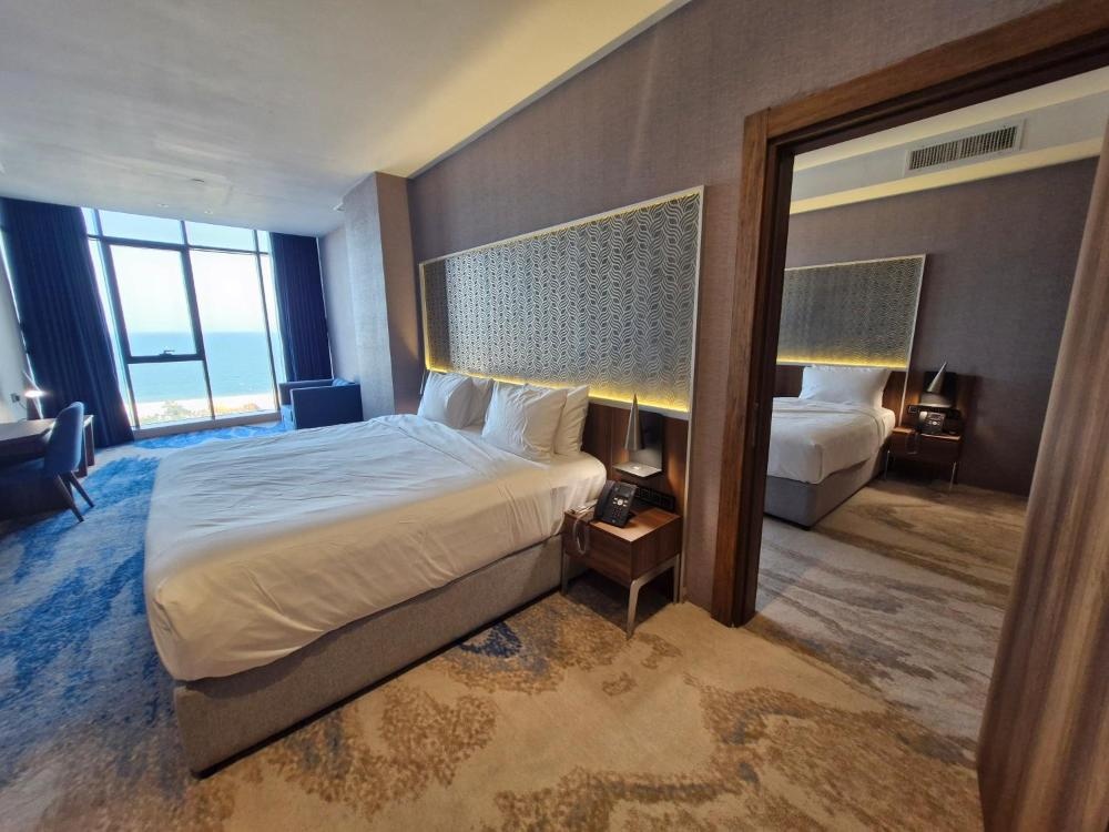 Double room at Ocean View Hotel Kuwait with patterned carpet and twin beds