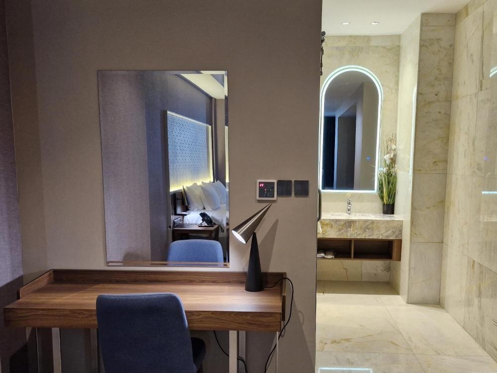 Ocean View Hotel Kuwait room with desk and wall-mounted mirror