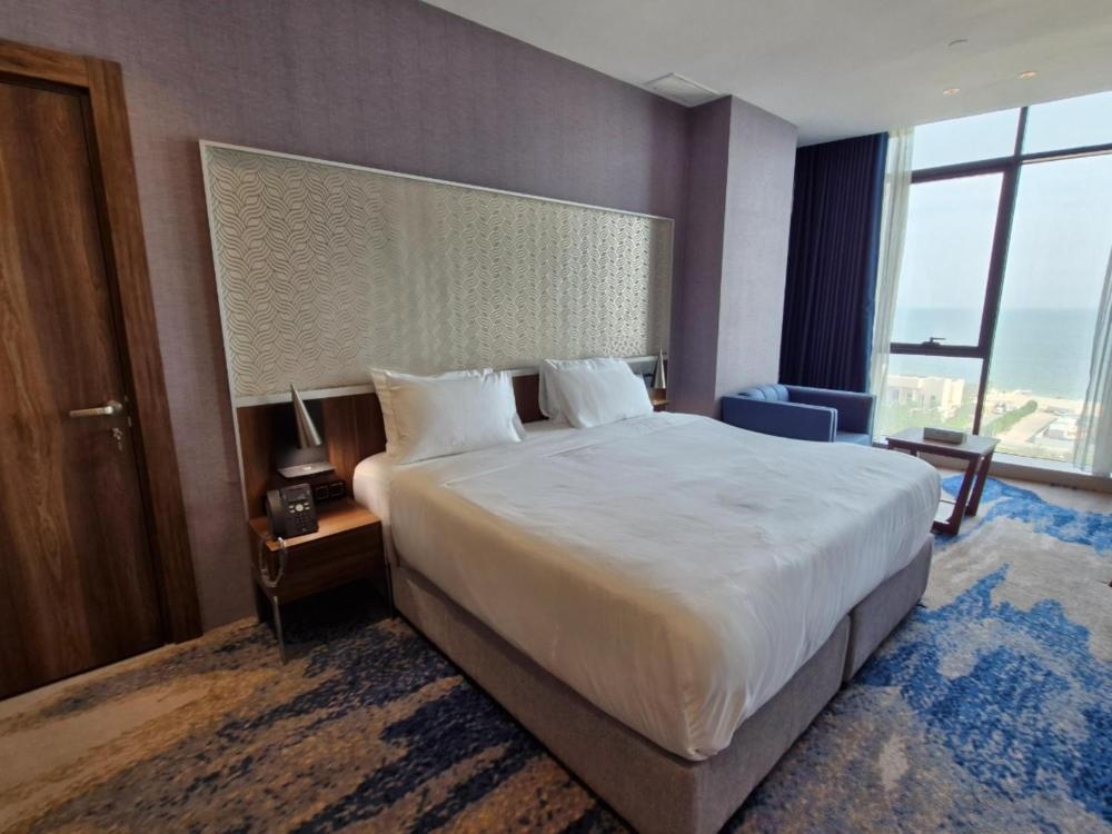 Ocean View Hotel Kuwait room with king bed and sea-facing windows
