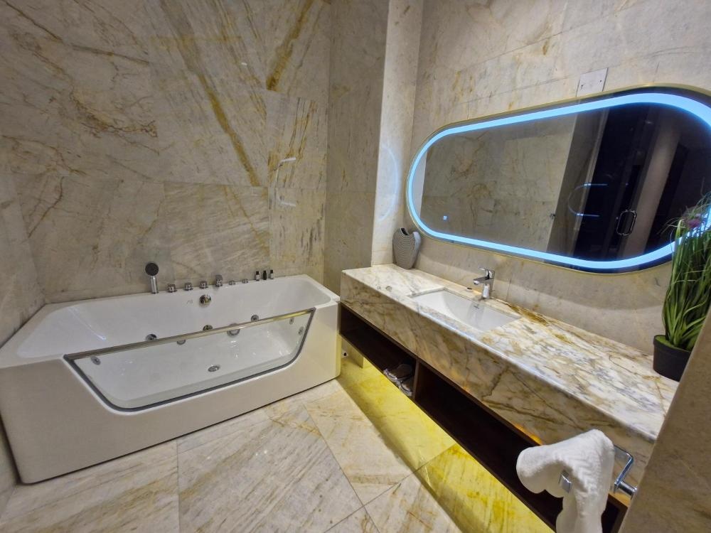 Hotel in Kuwait bathroom featuring whirlpool tub and vanity area
