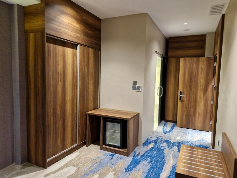 Hotel in Kuwait entryway with wardrobe and blue carpet