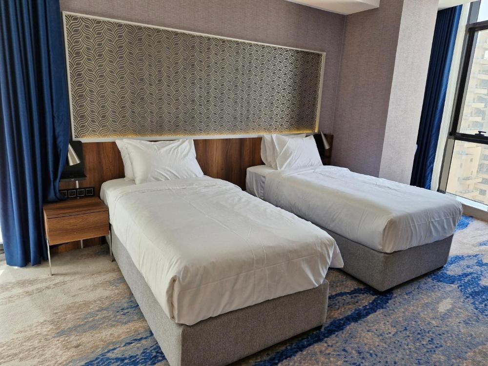 Hotel in Kuwait twin room with ottoman and large window