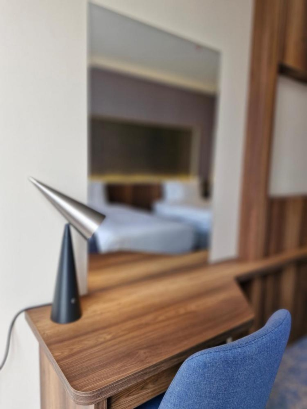 Desk and lamp in Hotel in Kuwait room with headboard reflection