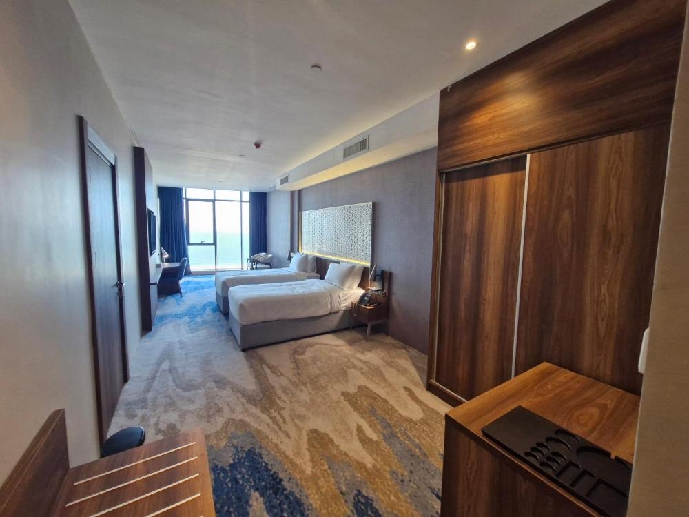 Ocean View Hotel Kuwait room with open layout and wood accents