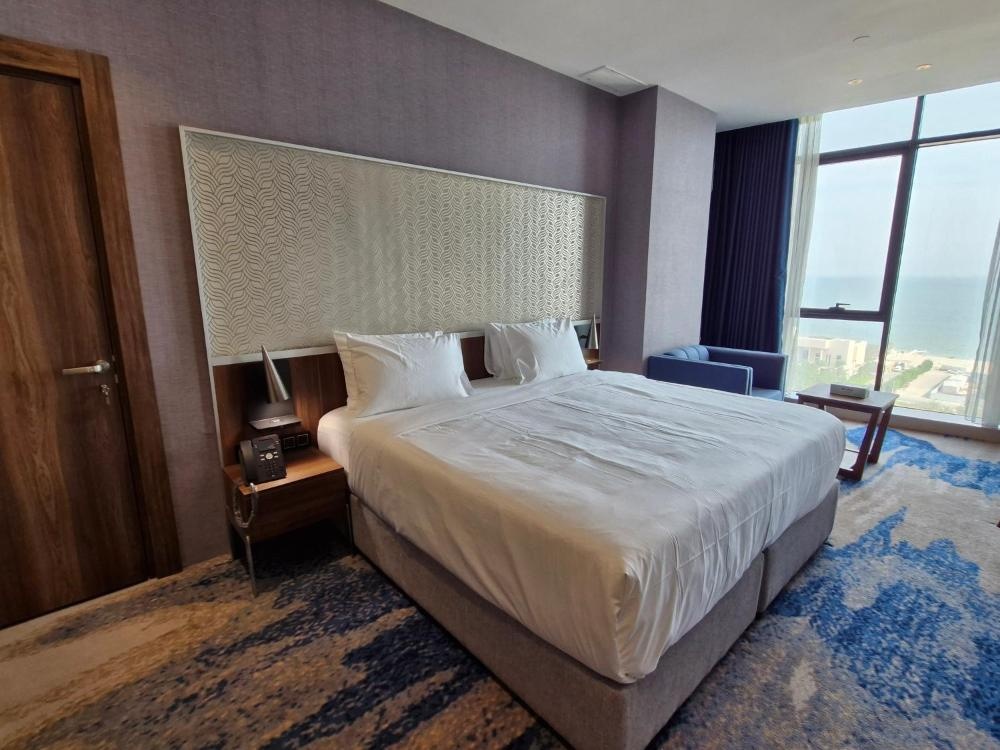 Hotel in Kuwait room with king bed and sea-facing windows